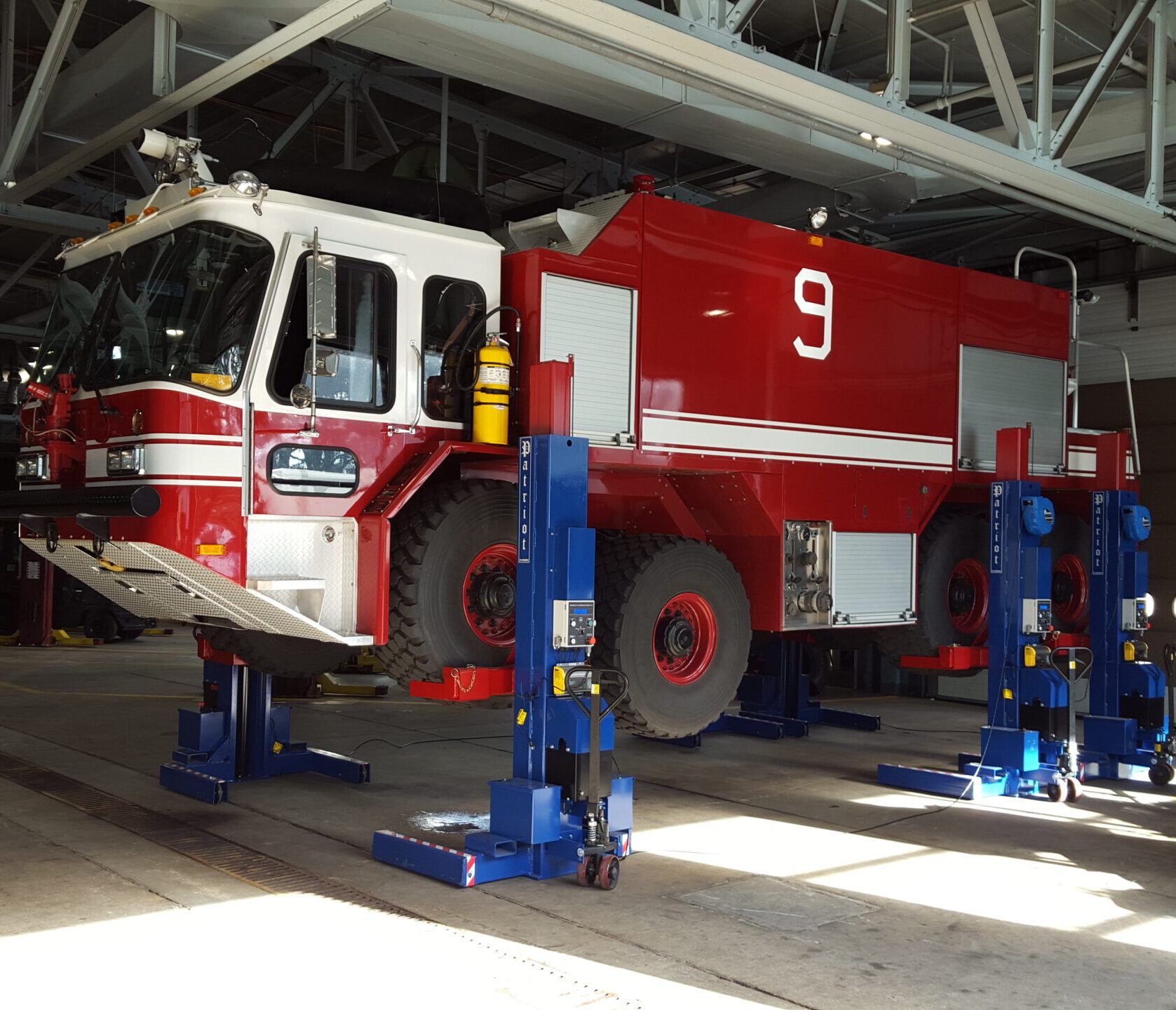 Patriot M-Series mobile column lifts raising a heavy-duty fire truck